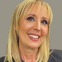 profile photo of Risa, smiling with blonde hair and a grey background